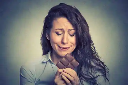young woman tempted by chocolate