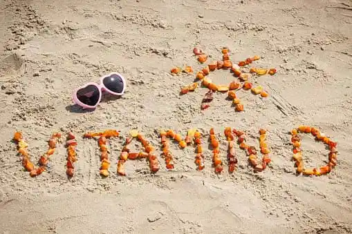 vitamin D written on sand